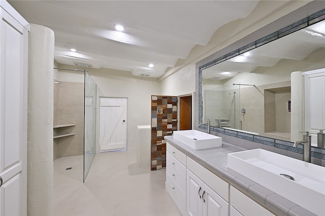 bathroom featuring beamed ceiling, vanity, and walk in shower