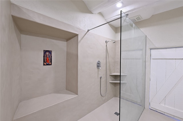 bathroom with a tile shower