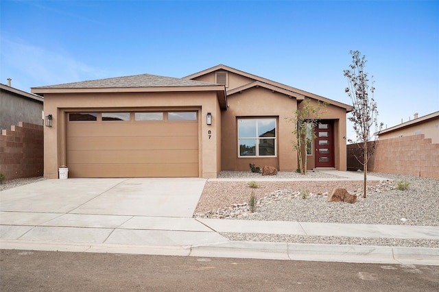 87 Cadena Loop, Los Alamos, NM 87547 - view of front of property featuring an attached garage, stucco siding, and driveway