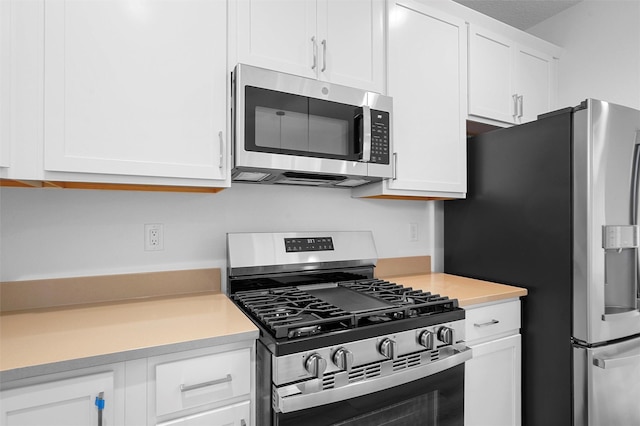 87 Cadena Loop, Los Alamos, NM 87547 - kitchen featuring appliances with stainless steel finishes, light countertops, and white cabinets