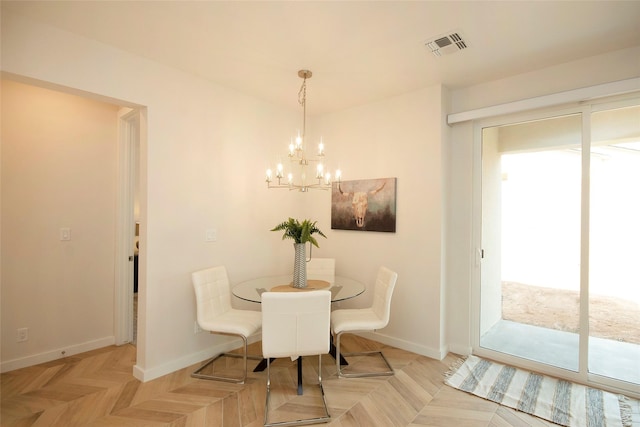 dining space featuring an inviting chandelier and light parquet floors