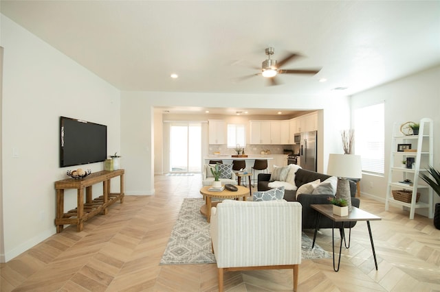 living room featuring light parquet floors and ceiling fan