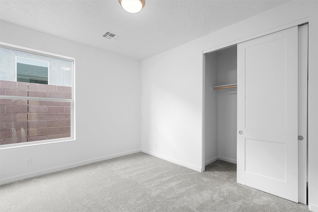 87 Cadena Loop, Los Alamos, NM 87547 - unfurnished bedroom featuring carpet floors, a closet, and a textured ceiling