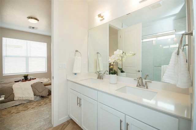 bathroom with vanity and a shower with shower door