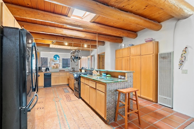 506 Dinkle, Edgewood, NM 87015 - kitchen featuring light brown cabinetry, wood ceiling, a skylight, beam ceiling, and black appliances