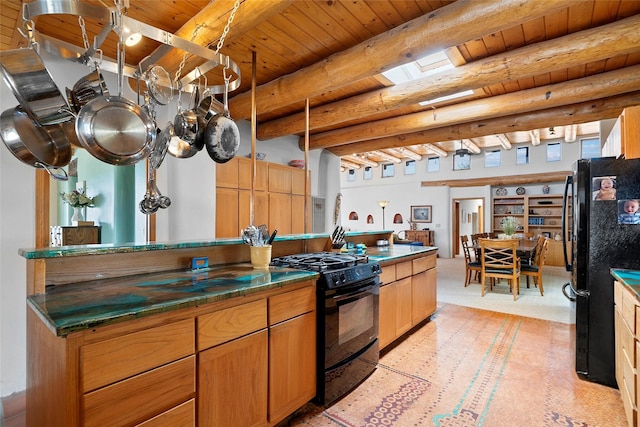 506 Dinkle, Edgewood, NM 87015 - kitchen featuring wood ceiling, beam ceiling, a skylight, and black appliances