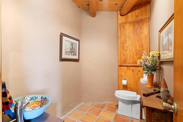506 Dinkle, Edgewood, NM 87015 - bathroom with toilet, tile patterned flooring, beam ceiling, and wooden ceiling