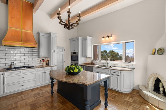 145 Brownell Howland, Santa Fe, NM 87501 - kitchen featuring stainless steel appliances, custom exhaust hood, a towering ceiling, a breakfast bar, and tasteful backsplash