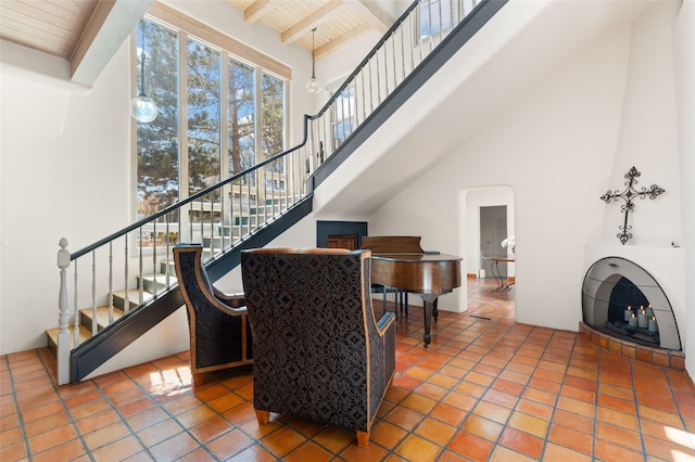 145 Brownell Howland, Santa Fe, NM 87501 - living area with stairway, wooden ceiling, a high ceiling, and beamed ceiling
