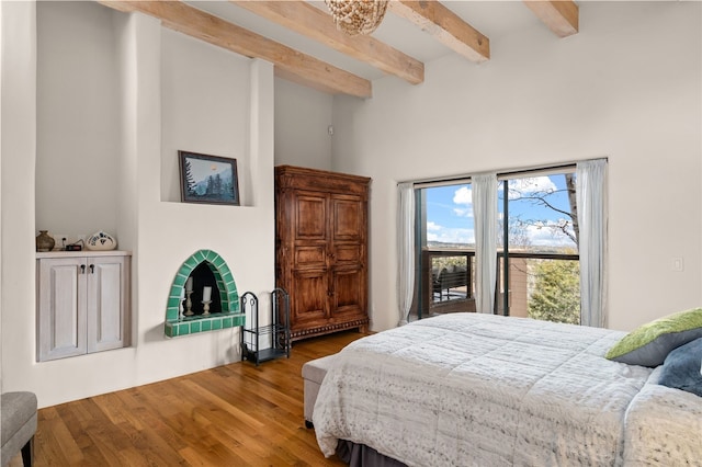 145 Brownell Howland, Santa Fe, NM 87501 - bedroom with beam ceiling, wood finished floors, and a high ceiling