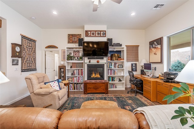 living room featuring dark hardwood / wood-style flooring and ceiling fan