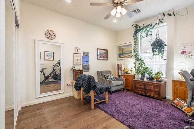 sitting room featuring ceiling fan and wood-type flooring