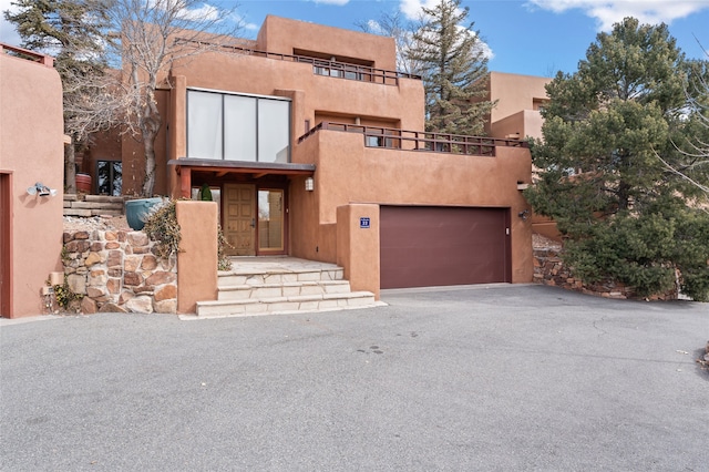 pueblo-style home featuring a garage