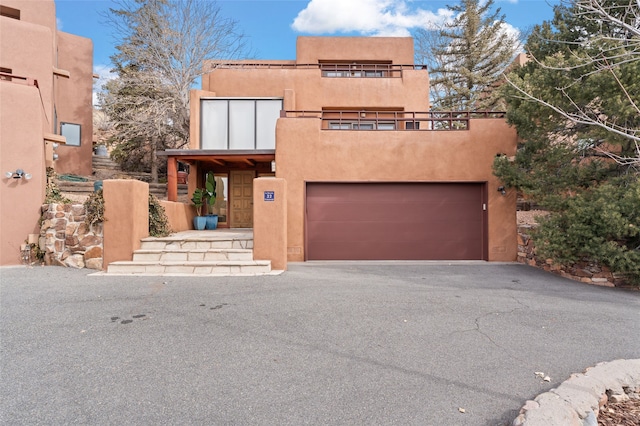 pueblo-style home featuring a garage