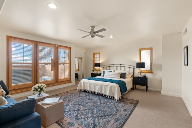 bedroom featuring light carpet and ceiling fan