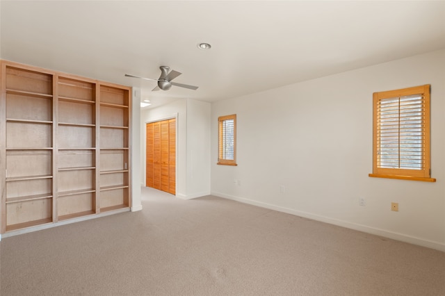 carpeted empty room with ceiling fan