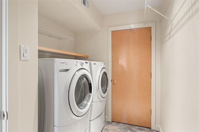 clothes washing area featuring washer and dryer