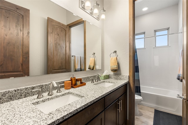 full bathroom with wood-type flooring, vanity, shower / tub combo with curtain, and toilet