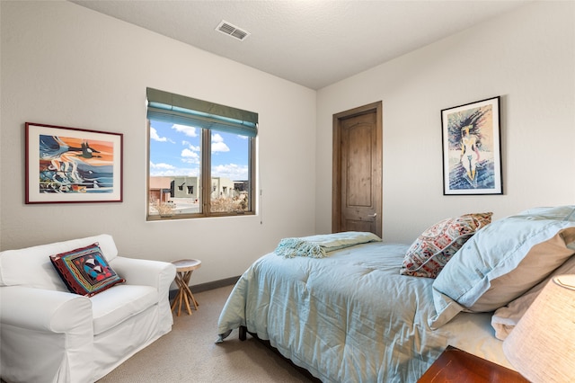 bedroom with carpet and a textured ceiling