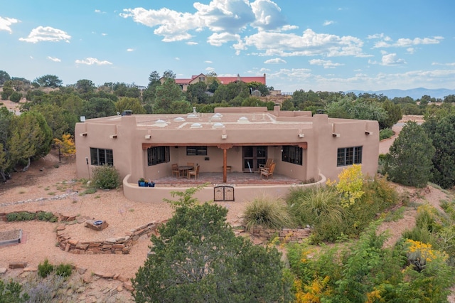 back of property with a patio