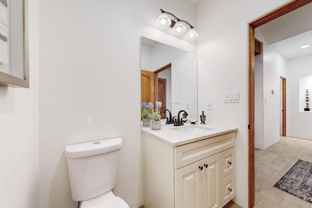 bathroom featuring toilet and vanity