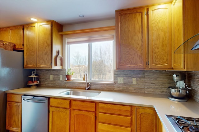 kitchen featuring appliances with stainless steel finishes, sink, and backsplash