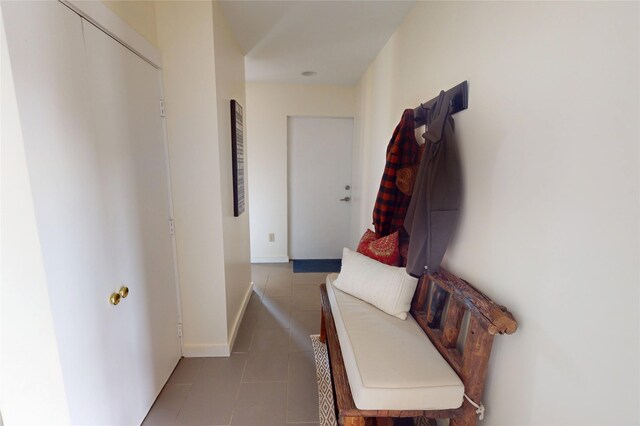 hallway with tile patterned floors