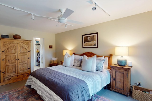 bedroom with tile patterned flooring, rail lighting, and ceiling fan