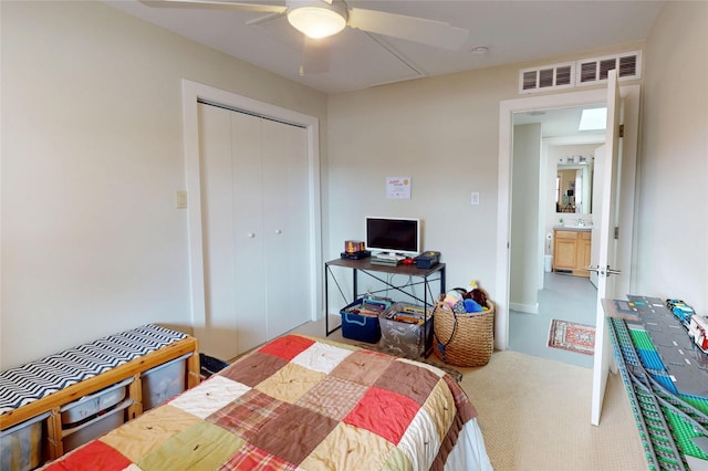 carpeted bedroom with ceiling fan and a closet