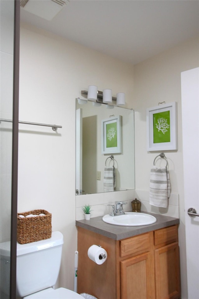 bathroom with toilet and vanity