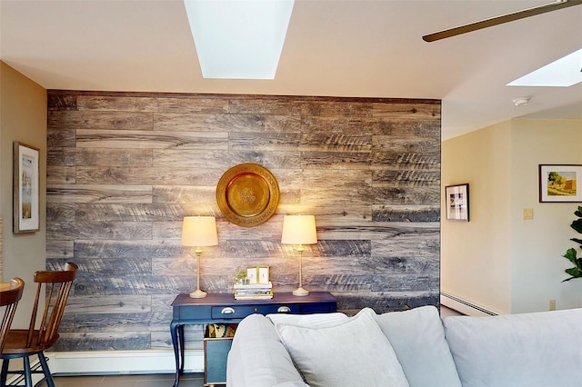 interior space with wooden walls, a skylight, and a baseboard radiator