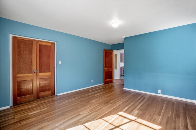 unfurnished bedroom with hardwood / wood-style flooring