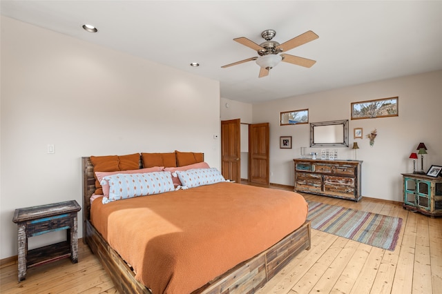 bedroom featuring ceiling fan and light hardwood / wood-style flooring