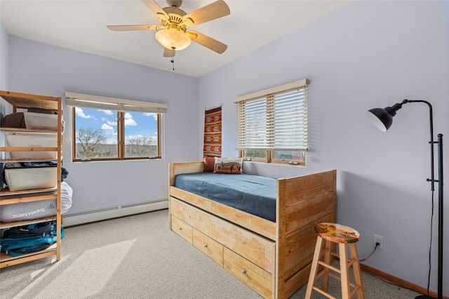 carpeted bedroom with multiple windows, ceiling fan, and baseboard heating