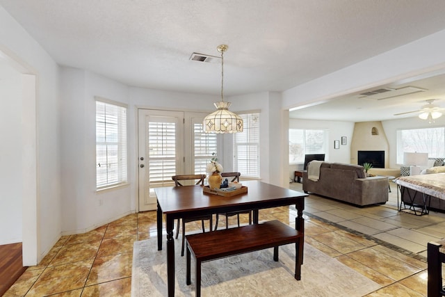 dining room featuring light tile patterned floors, ceiling fan, visible vents, and baseboards