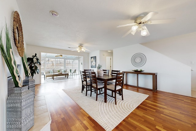 dining room with ceiling fan and wood finished floors