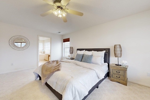 bedroom featuring baseboards, connected bathroom, a ceiling fan, and light colored carpet