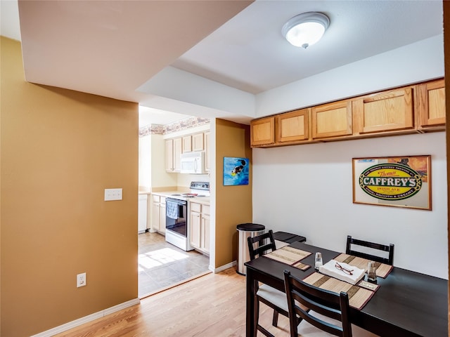 dining area featuring light wood-type flooring