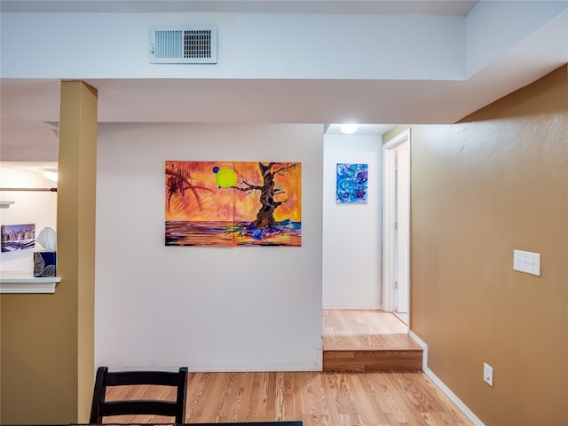 corridor with light hardwood / wood-style flooring