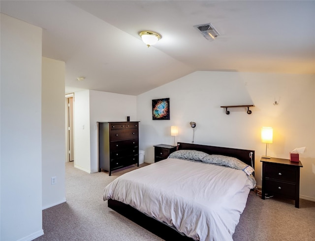 bedroom featuring vaulted ceiling and light colored carpet