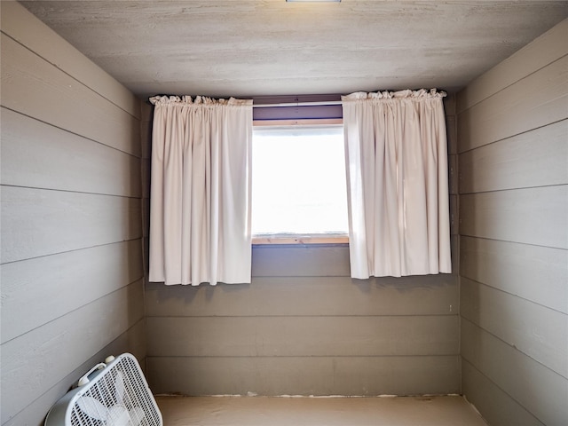 unfurnished room with wooden walls