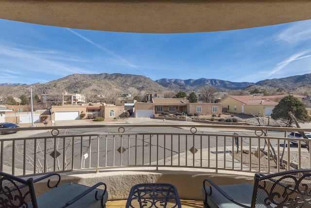 balcony with a residential view and a mountain view