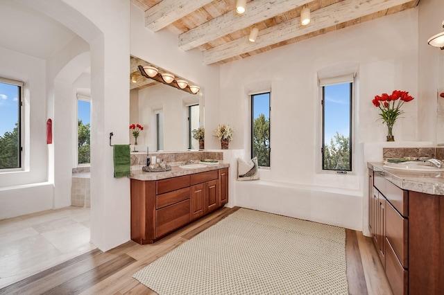 bathroom featuring wood ceiling, two vanities, a sink, and wood finished floors