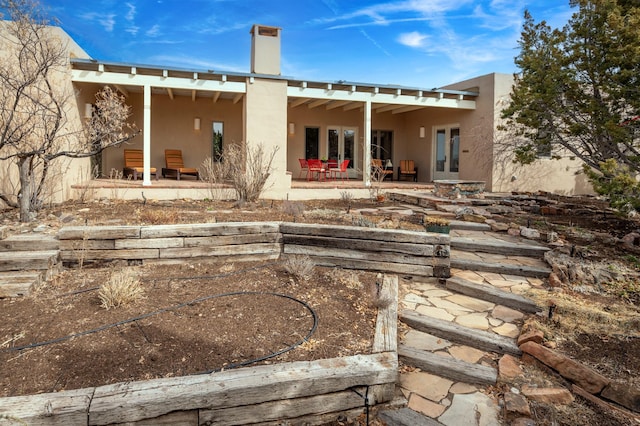 back of property featuring french doors, a patio, and stucco siding