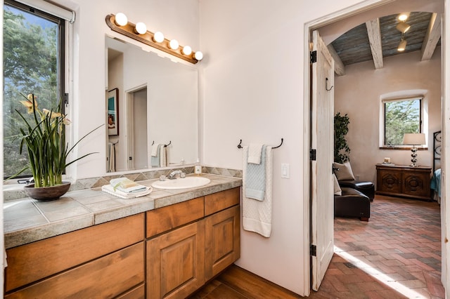 bathroom with brick floor and vanity