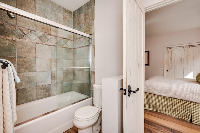 full bathroom featuring enclosed tub / shower combo and toilet