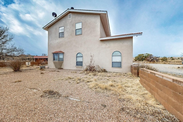 back of house featuring stucco siding