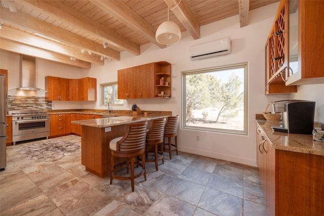 kitchen featuring brown cabinets, high end stove, a wall mounted air conditioner, a peninsula, and wall chimney exhaust hood