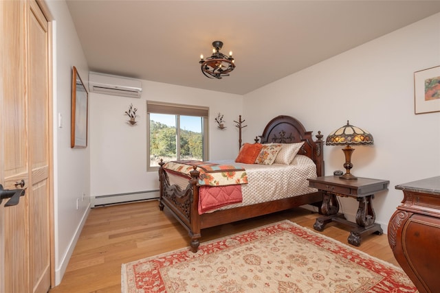 bedroom with a chandelier, a baseboard heating unit, baseboards, light wood-style floors, and a wall mounted air conditioner