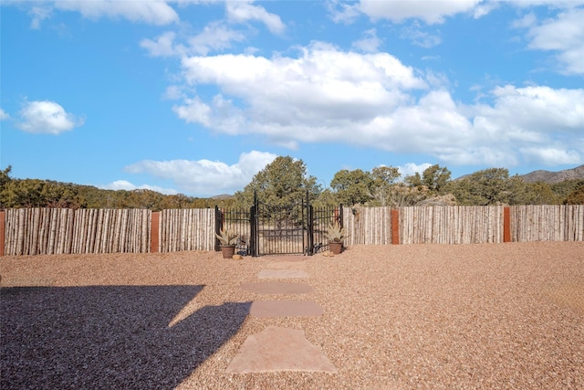 view of yard with a gate and fence